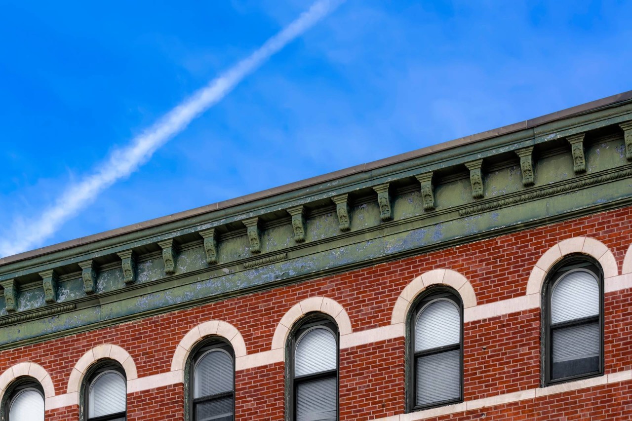 Hunter Douglas EverWood® Faux Wood Blinds on a brick office building with arched windows near Stoneham, Massachusetts (MA)