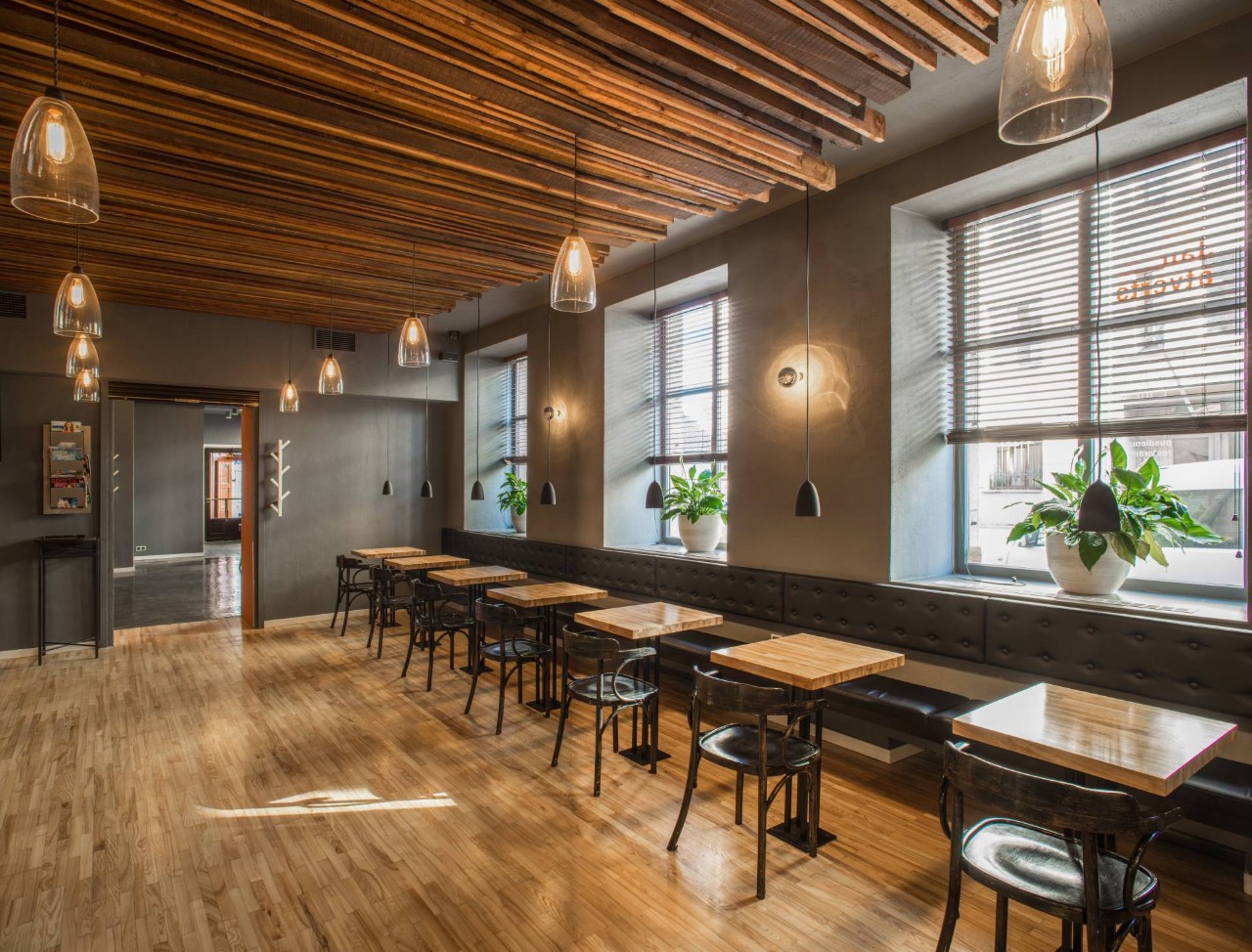 Restaurant with dark walls, metal accents, wood finishings, and window treatments for the oversized windows at Curtain Time near Stoneham, MA